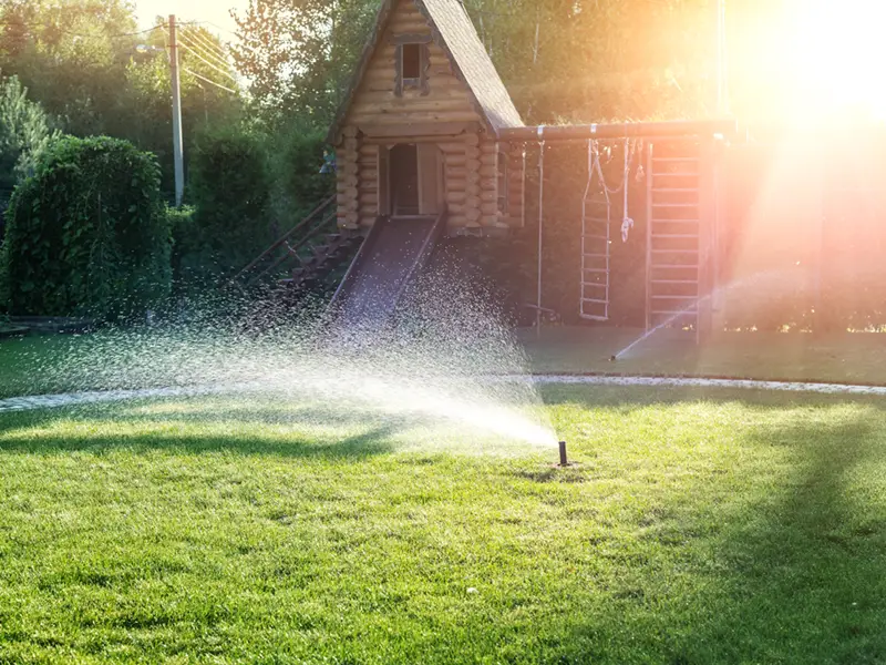 automatic garden watering system with different sprinklers installed